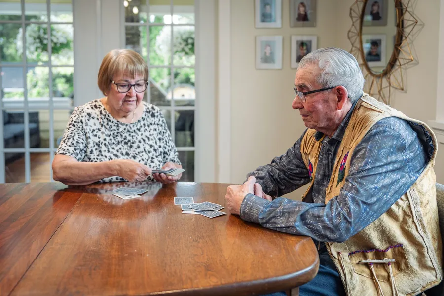 Memory matching game - senior couple playing cards together at home
