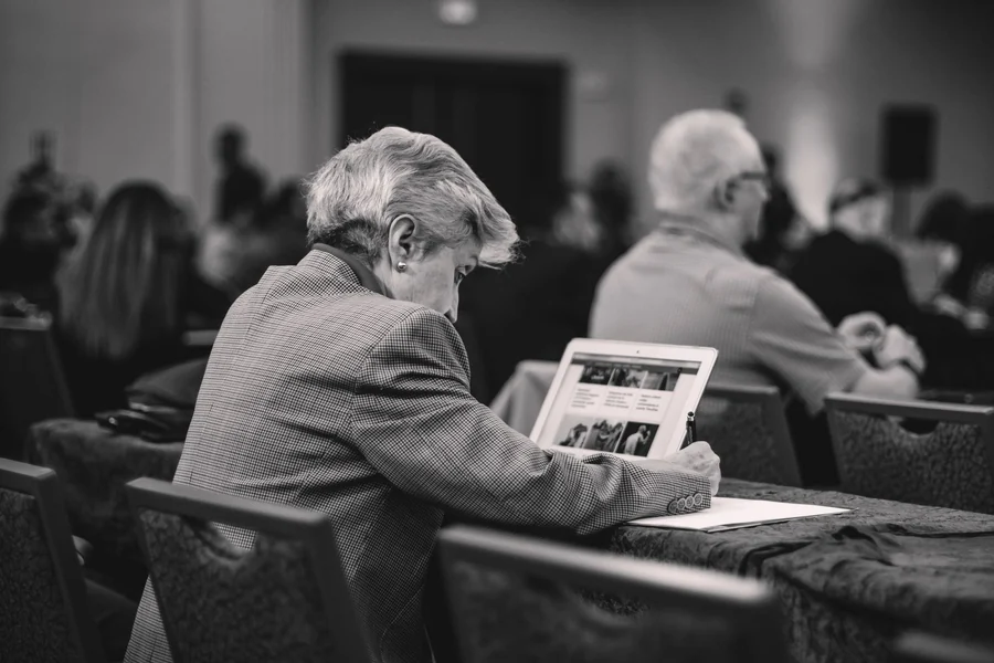 Pam Dawber net worth - journalist taking notes at a conference
