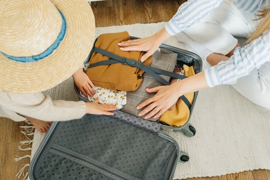 Princess Traveller suitcase review - a parent and child packing a suitcase together