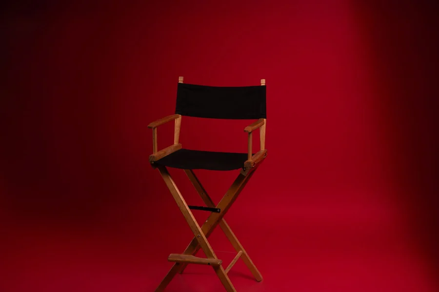 Snoop Dogg net worth - director's chair against a red backdrop