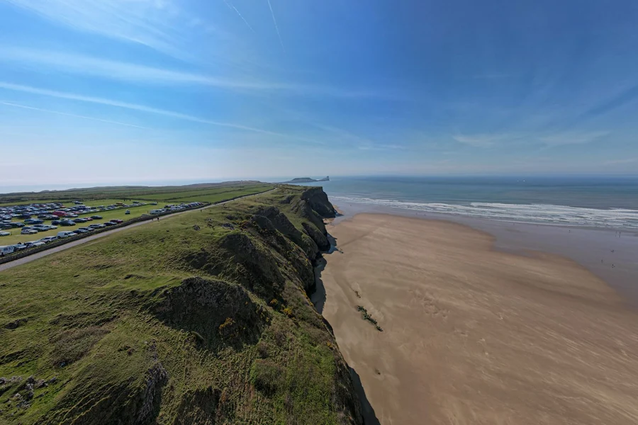 Snoop Dogg net worth - aerial view of Rhossili Bay near Swansea in Wales