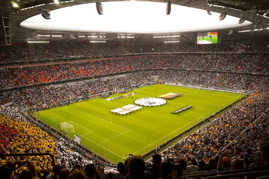 Snoop Dogg net worth - packed football stadium with fans watching a match