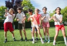 45 Best Summer Camp Games for Kids and Teens (Ages, Kit and Rain Plan) Group of children playing together outdoors in a park