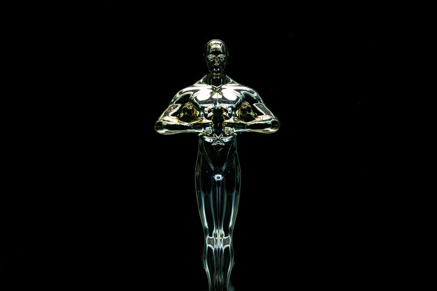 Tina Louise net worth - golden trophy statue on a black background