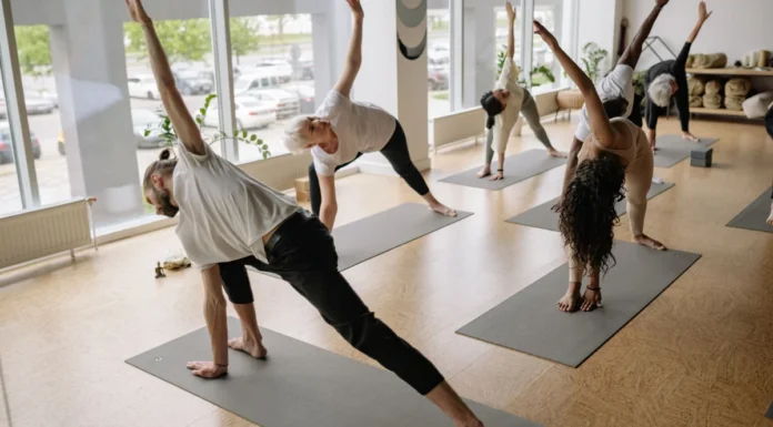 London’s Best Health and Wellness Events: What’s On in 2026-27 A diverse group of adults doing yoga poses on mats in a bright studio
