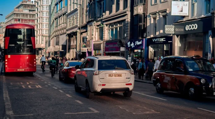 Top Industries for Businesses for Sale in London (Data Guide) A busy London street with a red bus, taxis and shop fronts on both sides