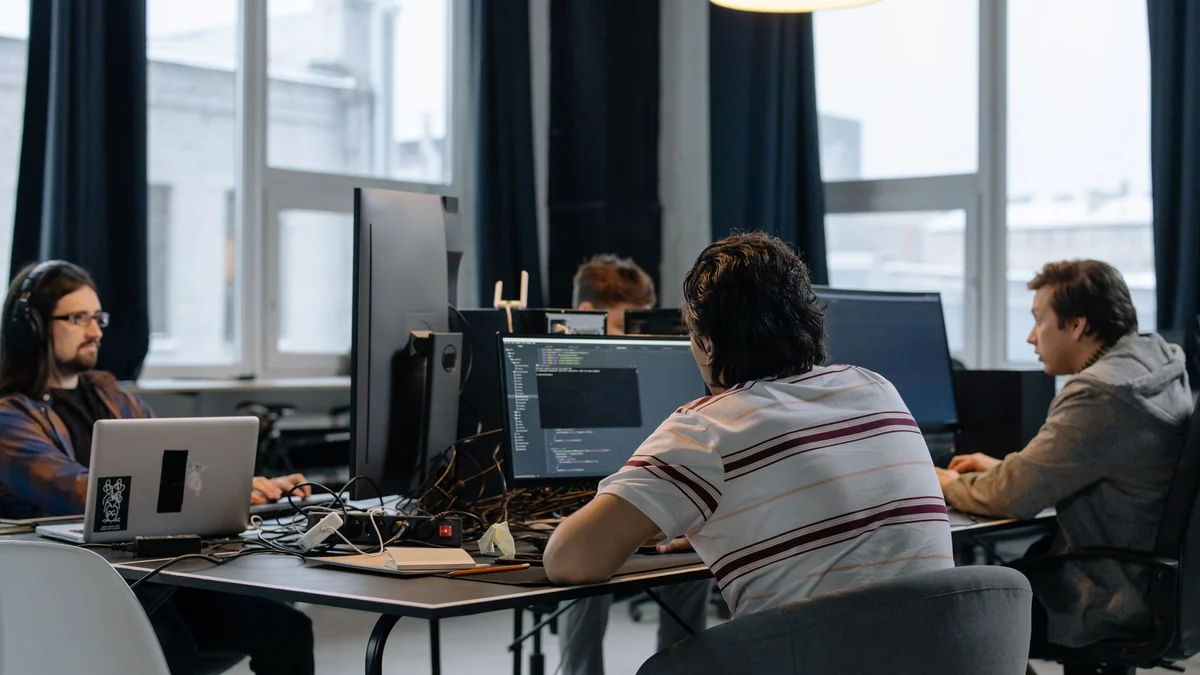 A team of developers working at computers in a bright open-plan office